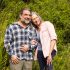 Happy mature couple enjoying nature walk, embracing and smiling in lush greenery, outdoors